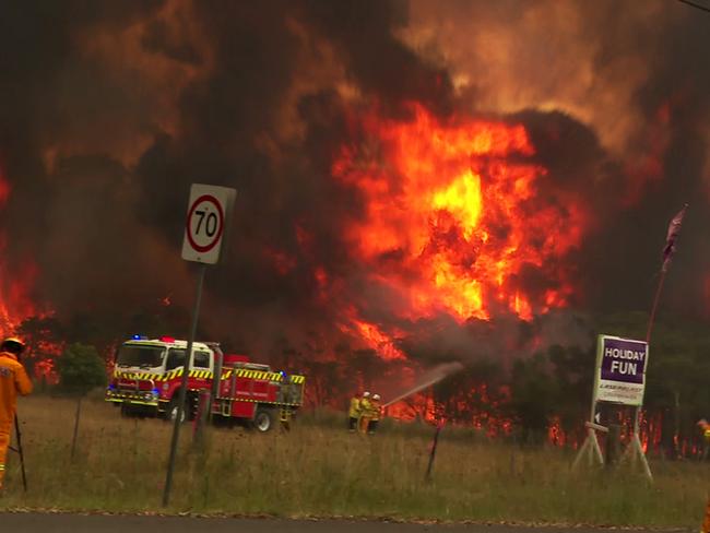 NSW Bushfires: Flames are seen engulfing bushland on Arizona Rd, Charmhaven. Picture: TNV