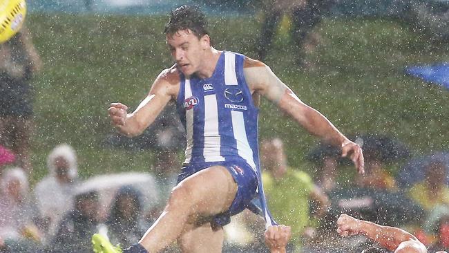 Action from the AFL match between the Gold Coast Suns and the North Melbourne Kangaroos, held at Cazalys Stadium, Cairns. North Melbourne's Shaun Atley gets the kick away from Gold Coast's Stephen May. PICTURE: BRENDAN RADKE