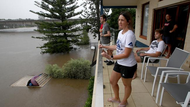 Heidi Van Den Broek and her family watch the flood levels rise from the balcony of their Bellevue Rd home on the banks of the Nepean River in Regentville. Picture: Toby Zerna