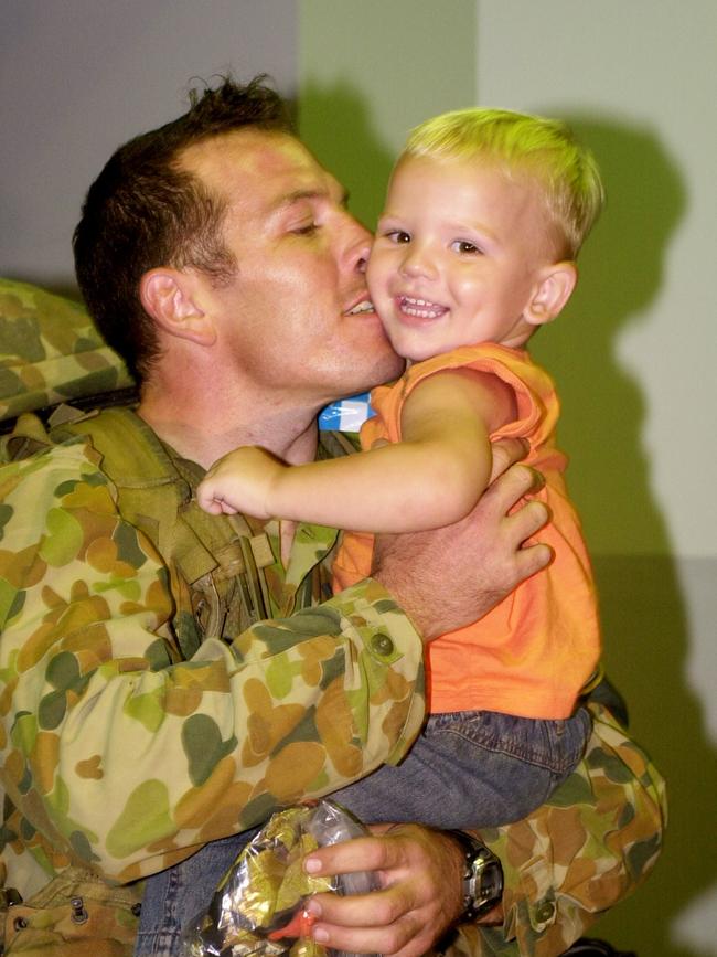 Australian Troops arriving at Townsville Airport from peace keeping in the Solomon Islands. Private Shane Hooper with son, Noah, 1. Picture: Stewart Mclean