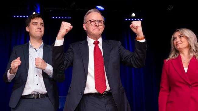 Australian Labor Prime Minister Anthony Albanese, pictured with partner Jodie Haydon and son Nathan Albanese, pumps the air after claiming victory in the federal election. Picture: Jason Edwards / NewsWire