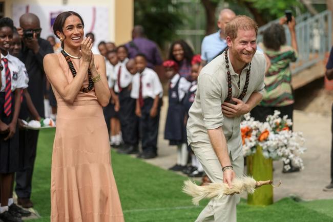 Britain's Prince Harry and his wife Meghan visit a school in Abuja to open an event on mental health for students