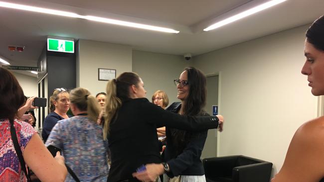 Community members hug CEO Sharon Kelsey after the vote was taken to sack her. PHOTO: JUDITH KERR