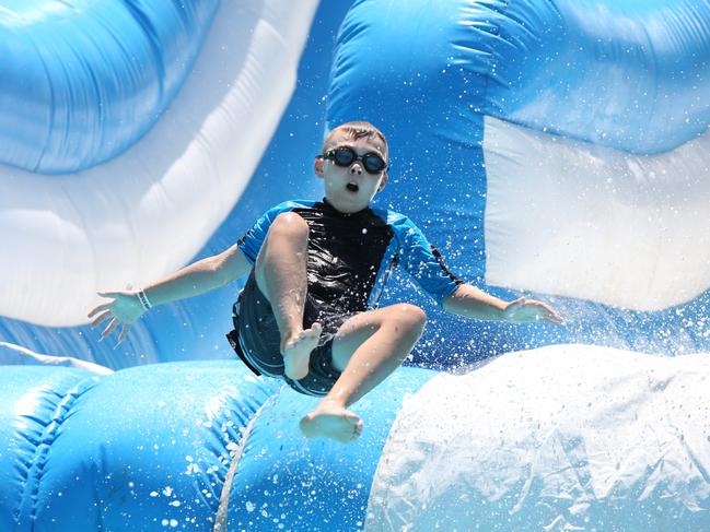 A youngster going down an inflatable waterside at the Water Wonderland, which has been set up for all to enjoy by the Campbelltown City Council. Picture: Robert Pozo