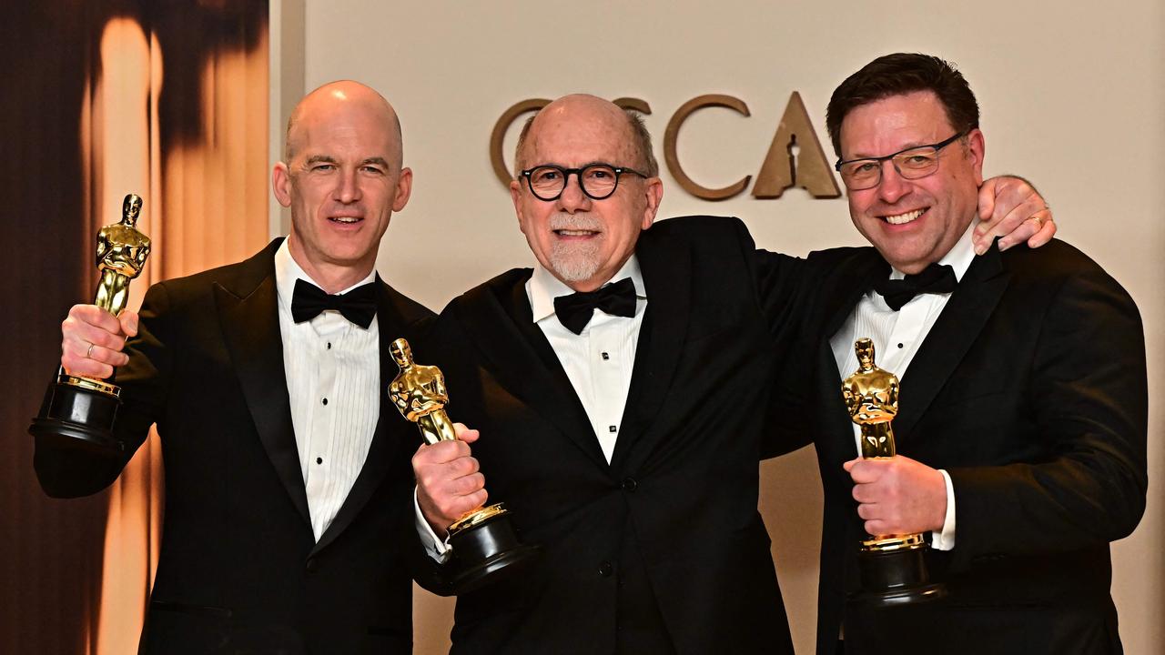 US sound designer Richard King, British sound engineer Gareth John and US sound designer Ron Bartlett with their Oscar for best sound. Picture: Frederic J. Brown / AFP