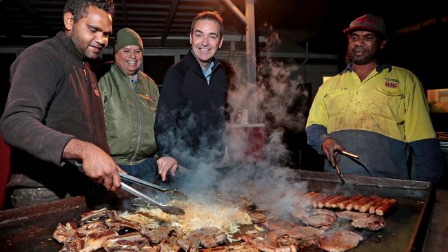 Steven Marshall shows he has the chops for cooking a barbecue. Watching his handiwork are, from left, Wayne Davis, Walter Chumley and Adam Richards. Picture: Dylan Coker