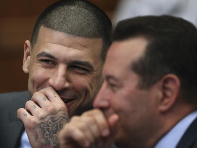 Aaron Hernandez laughs with defence lawyer Jose Baez during a hearing at Suffolk Superior Court. Picture: AP