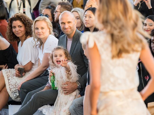 Rebecca Judd models at Melbourne Museum as husband Chris and children Billie and Oscar watch on. Picture: Stuart Walmsley