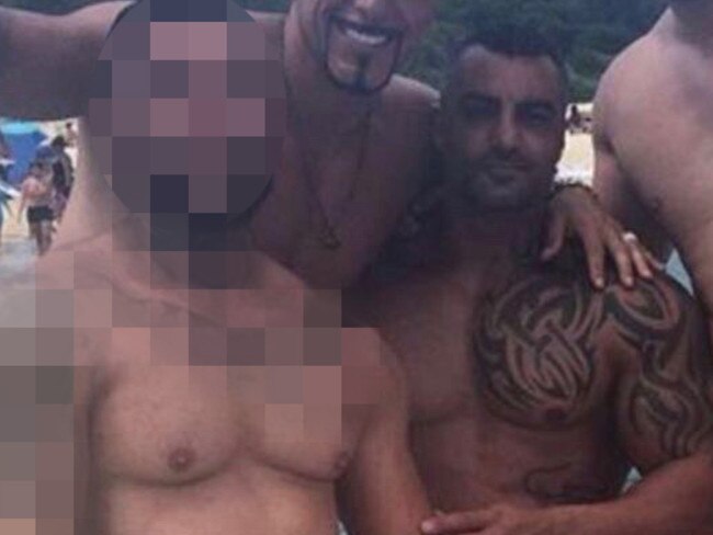 Mick Hawi (right) with his former friend Yusuf Nazlioglu (blurred image), who is accused of murdering him. (the other men in photo have no involvement in the charges)