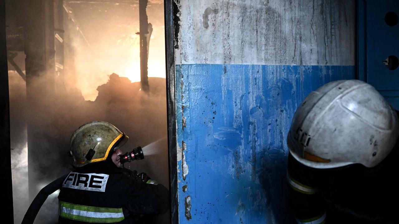 Firefighters work on a fire in a building after bombings on the eastern Ukraine town of Chuguiv. Picture: Aris Messinis / AFP