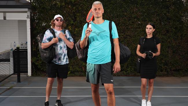 Bernard Tomic with hitting partner Cole Smith and Social Media manager Ashlee Rogers. Picture Glenn Hampson