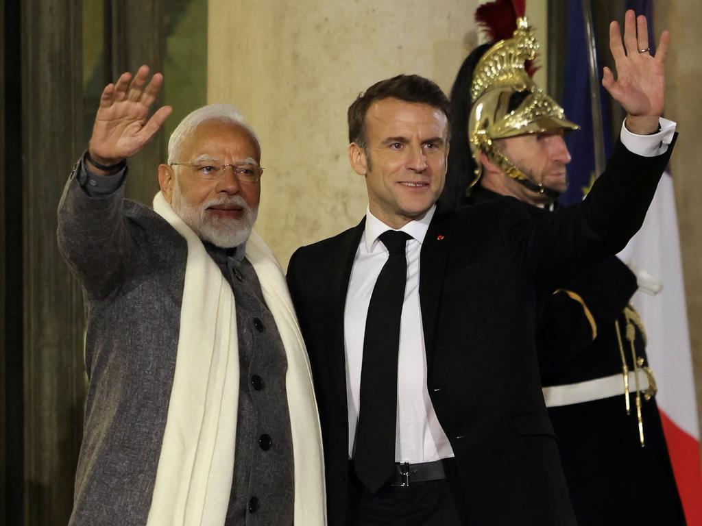 France's President Emmanuel Macron (front R) welcomes Indian Prime minister Narendra Modi as he arrives to attend a State dinner with World leaders and businessmen on the sideline of the Artificial Intelligence (AI) Action Summit, at the Elysee palace, in Paris, on February 10, 2025. (Photo by Thomas SAMSON / AFP)