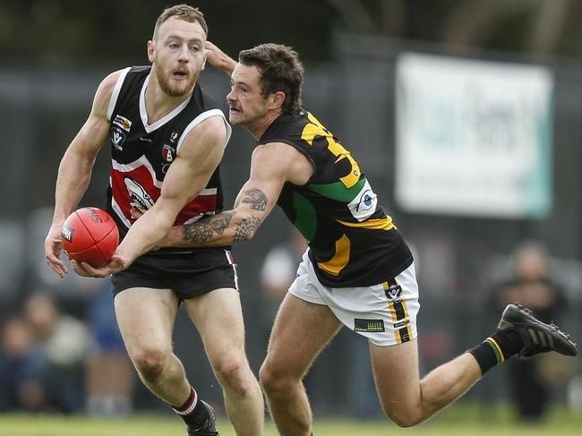 Bonbeach captain Jackson Casey is tackled by Dean Waugh. Picture: Valeriu Campan