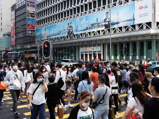 Pedestrians cross a street in Hong Kong. The territory may remain closed off well into next year. Picture: AFP