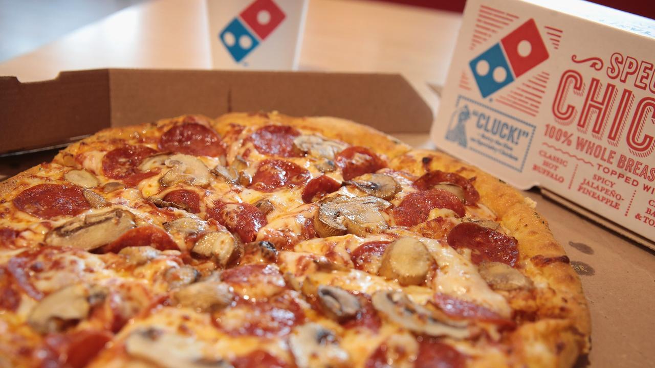 Dominos’ delivery drivers will leave pizzas at your door under a new plan. Picture: Scott Olson/Getty Images.