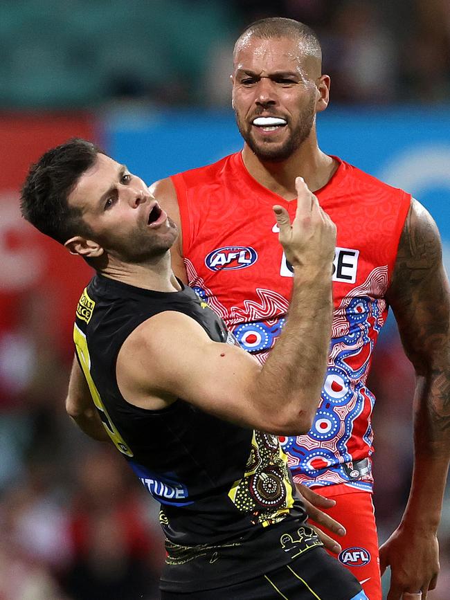 Trent Cotchin reacts after being struck.