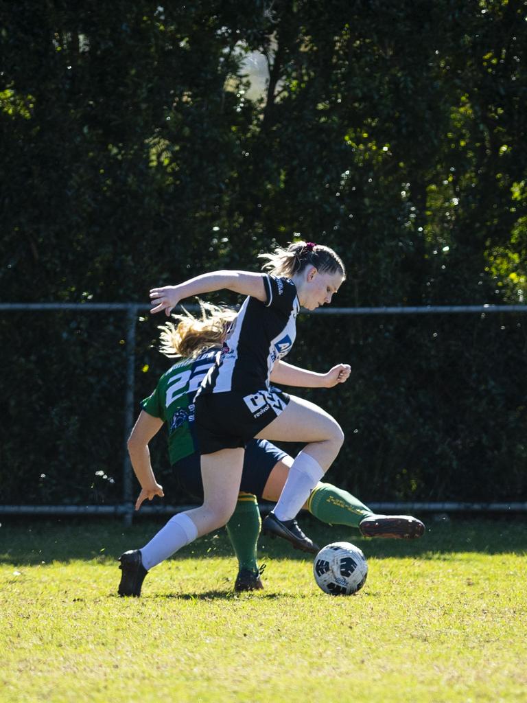 Brittany Menzies of Highfields tackles a Willowburn player in FQPL Women Darling Downs Presidents Cup football at West Wanderers, Sunday, July 24, 2022. Picture: Kevin Farmer