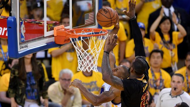 LeBron James blocks a shot by Andre Iguodala.