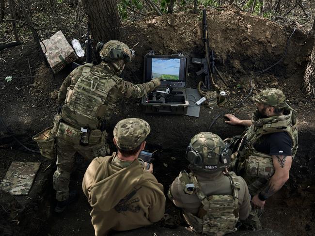 KHARKIV REGION, UKRAINE - MAY 16: Pilots of the "Sharp Kartuza" division of FPV kamikaze drones prepare drones for a combat flight on May 16, 2024 in the Kharkiv region, 8 km from the border with Russia. In recent days Russian forces have gained ground around the Kharkiv region, which Ukraine had largely reclaimed in the months following Russia's initial large-scale invasion in February 2022. (Photo by Kostiantyn Liberov/Libkos/Getty Images)