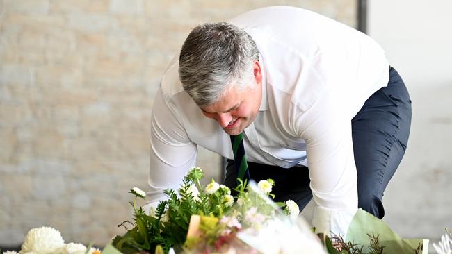 Police Minister Mark Ryan lays flowers in tribute to Vyleen White, 70, of Redbank Plains, who was stabbed to death in a shopping centre carpark. Picture: NCA Newswire/John Gass