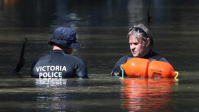 Victorian police divers search the Murray River for a missing boy on Friday, March 3, 2017, in Moama, New South Wales, Australia. Picture: Hamish Blair.