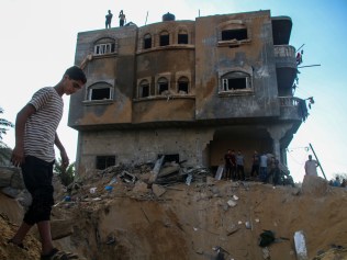 KHAN YOUNIS, GAZA - OCTOBER 16: Palestinian citizens inspect their home destroyed during Israeli raids in the southern Gaza Strip on October 16, 2023 in Khan Yunis, Gaza. Gazans are evacuating to the south following warnings to do so from the Israeli government, ahead of an expected Israeli ground offensive. Israel has sealed off Gaza and launched sustained retaliatory air strikes, which have killed at least 2,500 people with more than 400,000 displaced, after a large-scale attack by Hamas. On October 7, the Palestinian militant group Hamas launched a surprise attack on Israel from Gaza by land, sea, and air, killing over 1,300 people and wounding around 2,800. Israeli soldiers and civilians have also been taken hostage by Hamas and moved into Gaza. The attack prompted a declaration of war by Israeli Prime Minister Benjamin Netanyahu and the announcement of an emergency wartime government. (Photo by Ahmad Hasaballah/Getty Images)