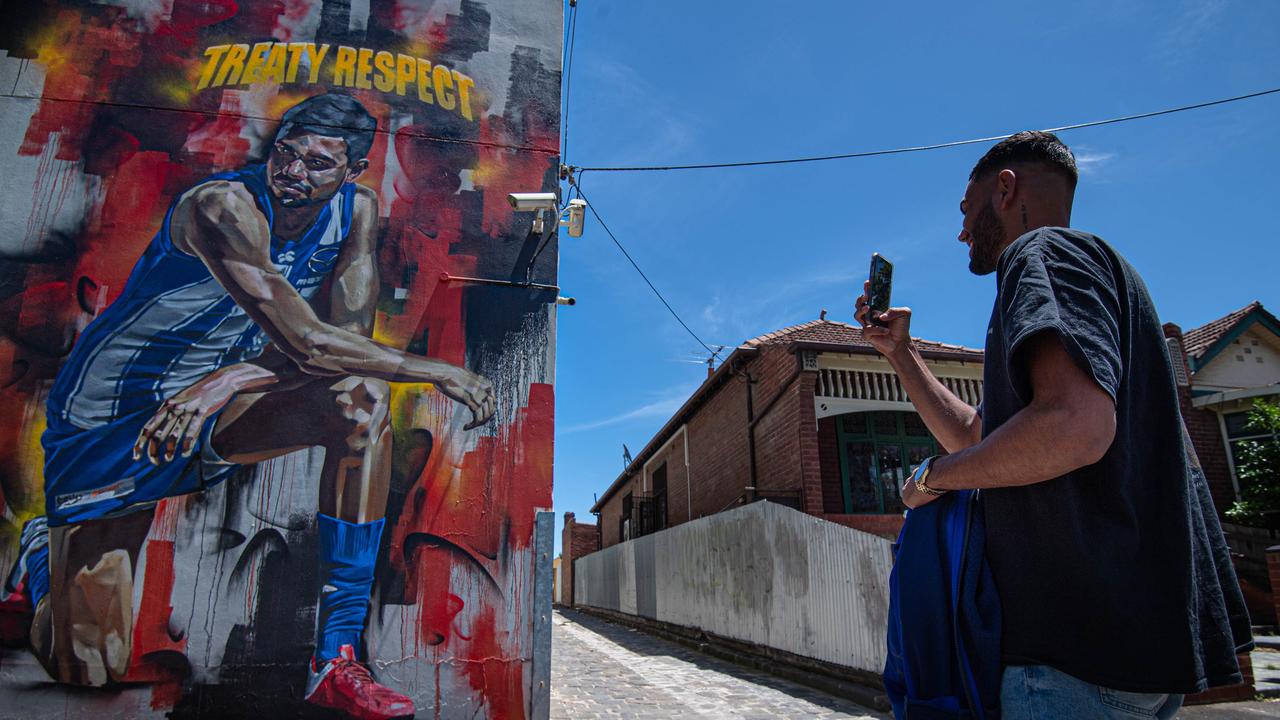 Tarryn Thomas in front of the Black Lives Matter mural of him. Picture in North Melbourne: Jason Edwards