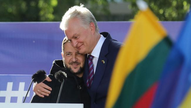 Volodymyr Zelensky is embaced by Lithuanian President Gitanas Nauseda at Lukiskiu Square in Vilnius on Tuesday. Picture: AFP