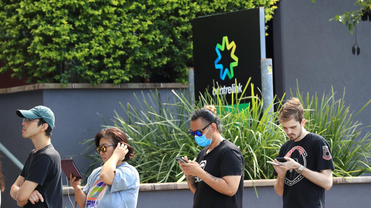 Lines of people wait at Southport Centrelink. Picture: Adam Head.