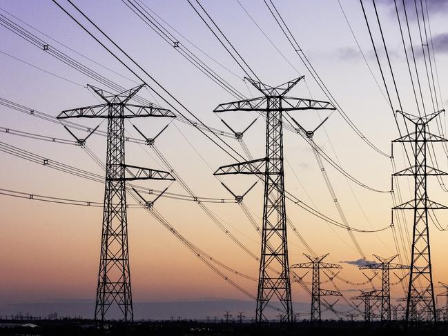 Electricity pylons during dusk evening sky sunset.