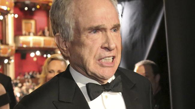 Warren Beatty exits the stage after announcing the award for best picture at the Oscars on Sunday, Feb. 26, 2017, at the Dolby Theatre in Los Angeles. (Photo by Matt Sayles/Invision/AP)