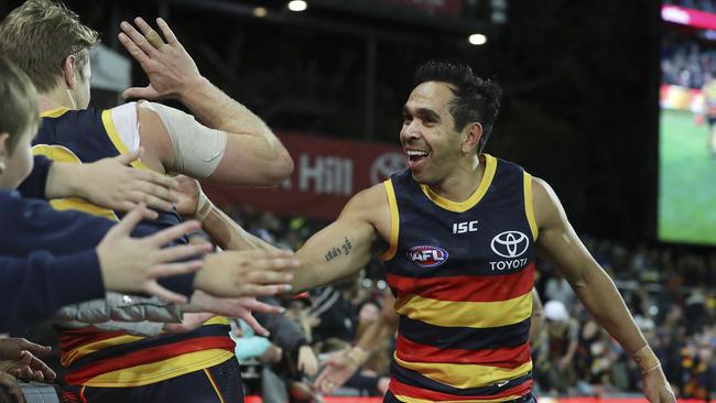 Eddie Betts celebrates with Crows co-captain Rory Sloane and fans after an win this season. Picture SARAH REED