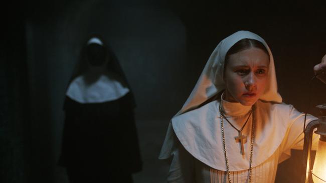 Taissa Farmiga as Sister Irene (foreground) in a scene from film The Nun