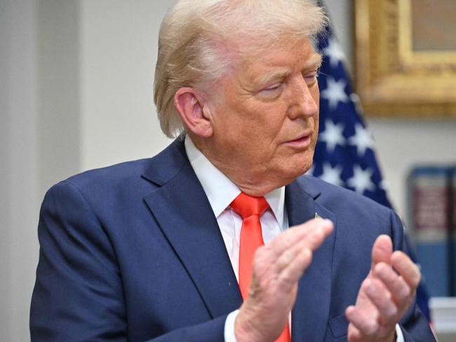 US President Donald Trump applauds C.C. Wei, Chairman and CEO of TSMC, in the Roosevelt Room of the White House in Washington, DC, on March 3, 2025. Trump said chip-making giant TSMC will invest "at least" $100 billion in the United States to build "state of the art" chip manufacturing facilities. (Photo by ROBERTO SCHMIDT / AFP)