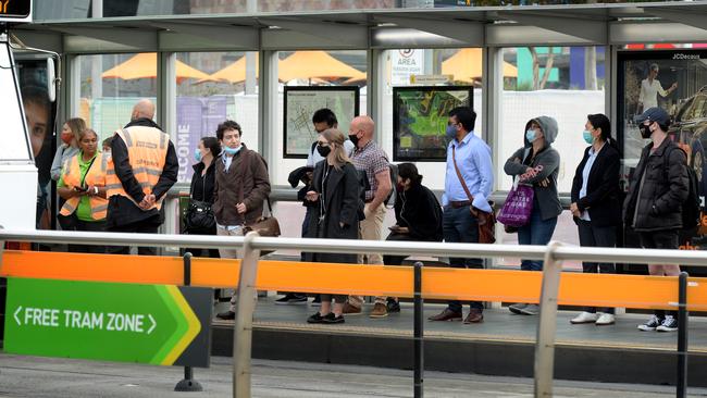 State government surveys from April show just 50 per cent of people aboard trains and 55 per cent on trams wore masks as required. Picture: Andrew Henshaw