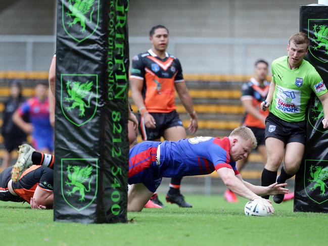 Newcastle number 18, Noah Ryan dives over. Picture: David Swift