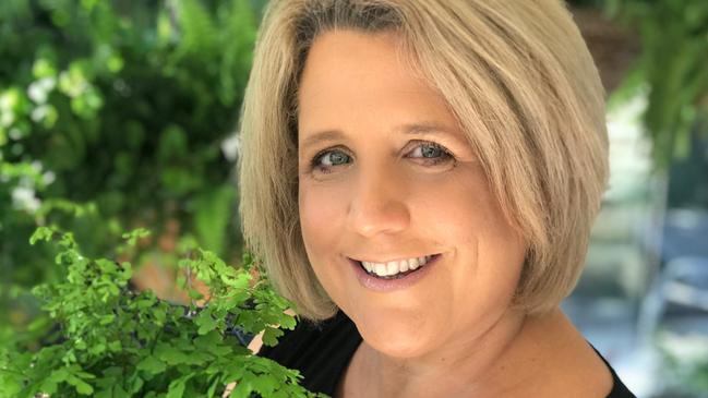 University lecturer Susan Sullivan with a kokedama she creates for her side hustle business, koke.com.au