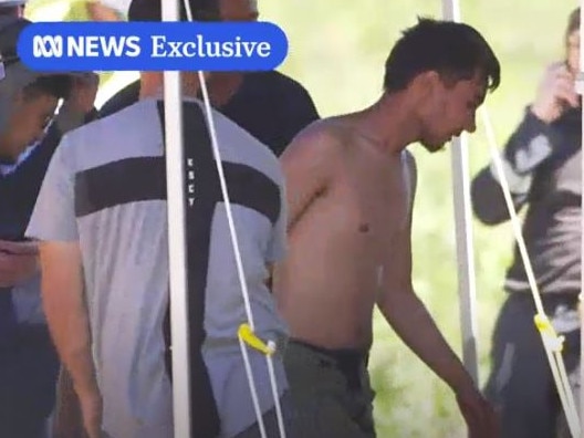 Hadi Nazari seen bare-chested with friends after he was found alive. Picture: ABC/Adriane Reardon.