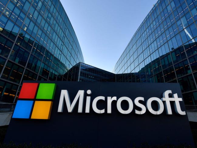 (FILES) The logo of French headquarters of American multinational technology company Microsoft, is pictured outside on March 6, 2018 in Issy-Les-Moulineaux, a Paris' suburb. Microsoft on May 13, 2025 said it was slashing unnecessary layers of management and seizing the benefits of new technology as reports said the tech behemoth was laying off thousands of workers. The company, which is advancing in its plans of deploying AI across all its products, also said it was in a process to 