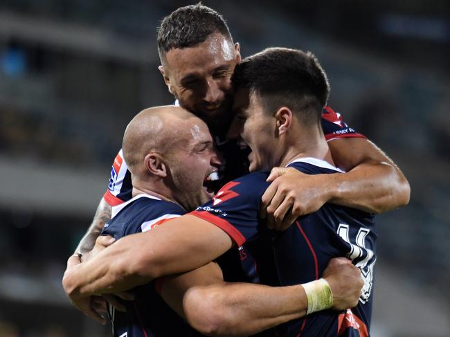 Rebels Billy Meakes and Quade Cooper congratulate Jack Maddocks after he scores a try. Picture: AAP Image/Mick Tsikas