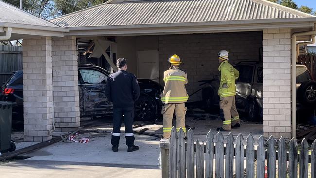 The black BMW smashed through a side fence and into the garage of the home, colliding with a parked car and injuring the home's owner.