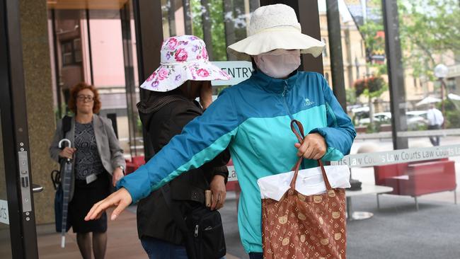 Family of Yueqiong Fu cover their faces after attending her bail hearing. Picture: AAP