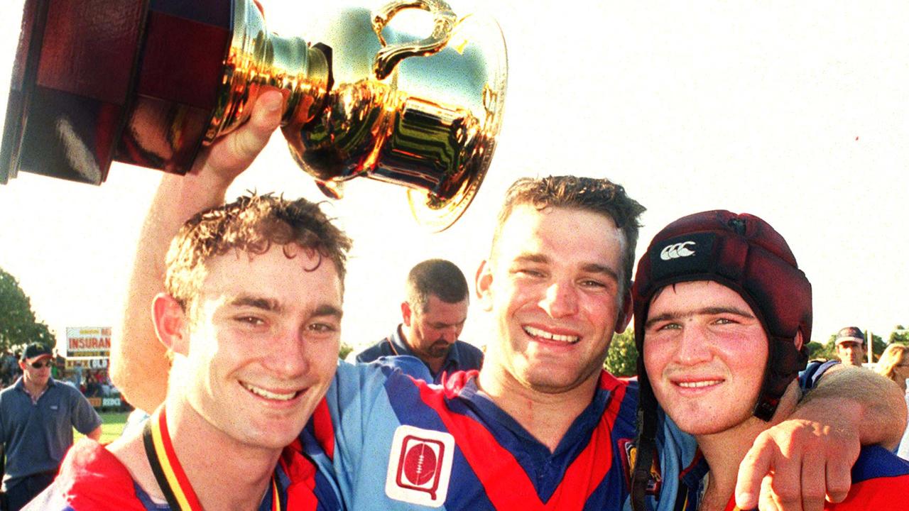 Clydesdales (from left) Tony Duggan, Darren Ingram and Nathan Friend celebrate their 2001 Queensland Cup win. Picture: Nev Madsen