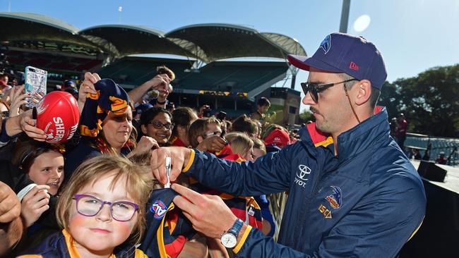 Dejected Adelaide skipper Taylor Walker signs autographs for loyal Crows fans at Adelaide Oval the day after last year’s Grand Final loss. Picture: Tom Huntley