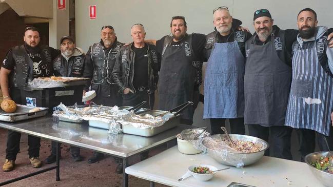 Mr Wandel (third from right in denim apron) at a charity event with his Knights SMC cohort. Picture: Supplied.