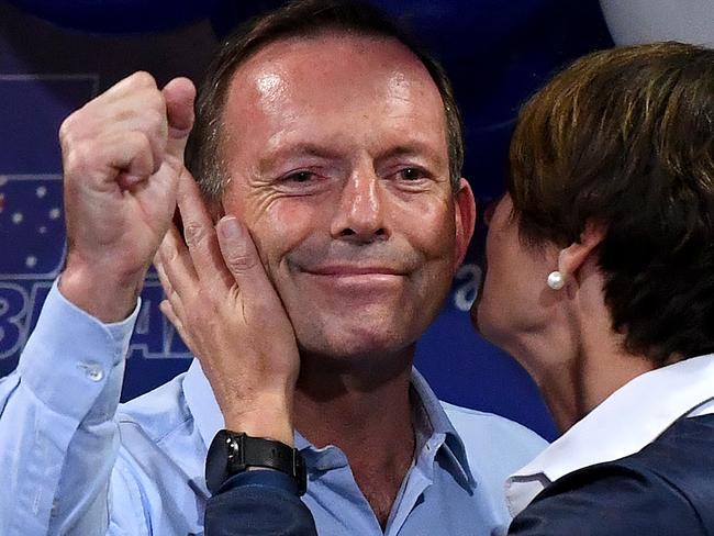 Former Prime Minister and Warringah Liberal candidate Tony Abbott raises his fist as he receives a kiss onstage from his wife Margie after conceding defeat at Manly Leagues Club in Brookvale, Sydney, Saturday, 18 May, 2019. Approximately 16.5 million Australians have voted  in what is tipped to be a tight election contest between Australian Prime Minister Scott Morrison and Australian Opposition leader Bill Shorten. (AAP Image/Bianca De Marchi) NO ARCHIVING