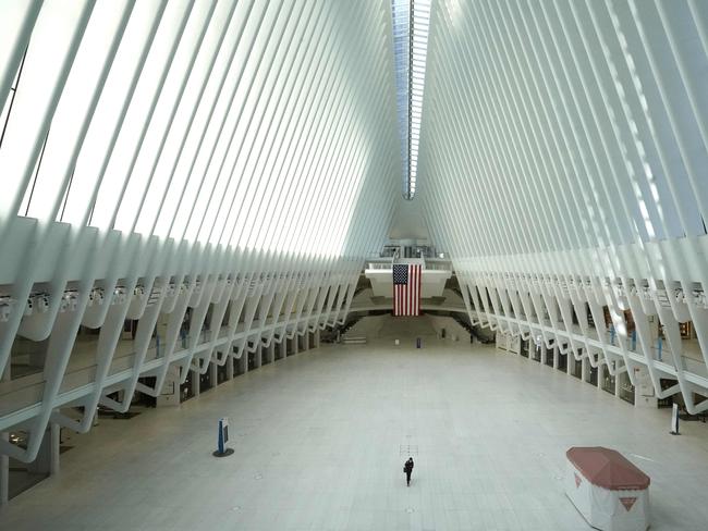 A person walks through the glass and steel structure called the Oculus which serves as the World Trade Centre transport hub. Picture: AFP