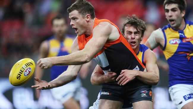 Heath Shaw handballs while being tackled by Luke Partington. Picture: Phil Hillyard