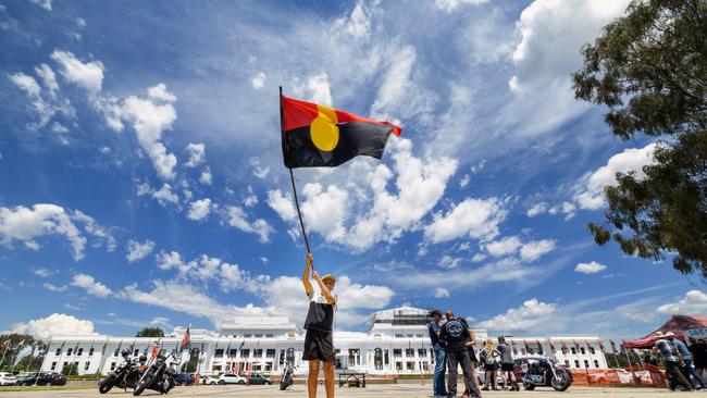 CANBERRA, AUSTRALIA - NewsWire Photos JANUARY 26, 2023: A small crowd gathered at the Aboriginal Tent Embassy, on the lawns of Old Parliament House, in Canberra to mark Invasion day. Ngunnawal boy, Tahlen Bell, 12 yers old, from Yass with the indigenous flag.Picture: NCA NewsWire / Gary Ramage