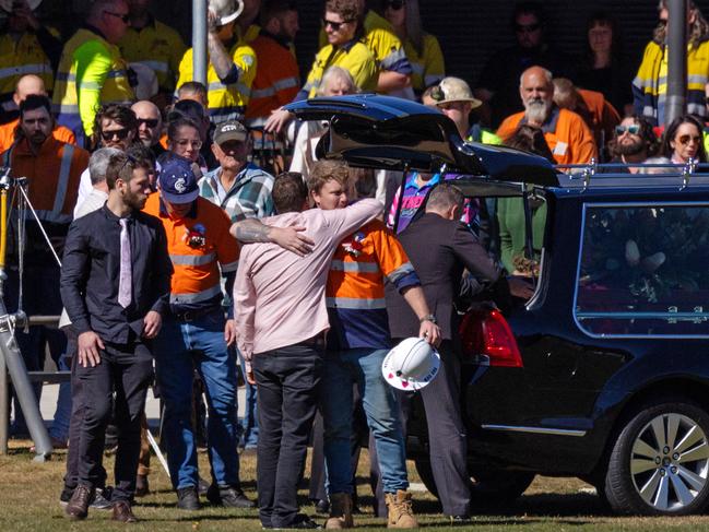 Mourners embrace at Kurt Hourigan’s funeral service. Picture: Mark Stewart